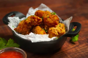 Buffalo Wild Wings Garlic Parmesan Wing Sauce served with crispy chicken wings.