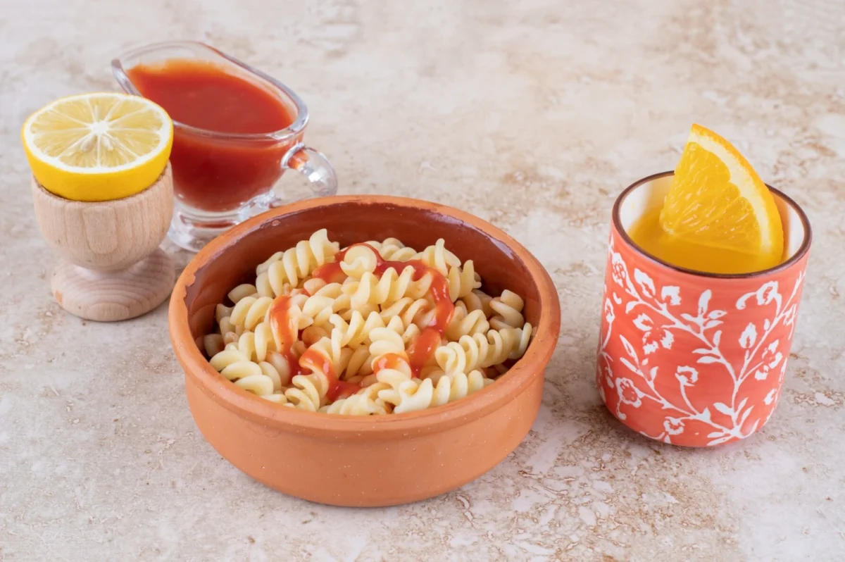 A vibrant plate of feta pasta adorned with fresh herbs and a rich tomato sauce.