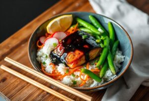 A delicious sticky miso salmon bowl with glazed salmon, colorful vegetables, white rice, and garnishes, set on a wooden table. Beside it rests a pair of chopsticks.