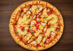 A delicious pineapple pizza topped with BBQ chicken and fresh ingredients.